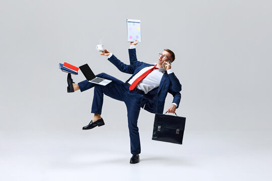 Businessman multitasking, balancing with coffee cup, laptop, and phone in dynamic stance, showcasing art of handling it all. Concept of business, multitasking, balance, corporate life, productivity.
