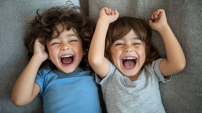 Two young siblings posing for a silly picture, making goofy faces at the camera