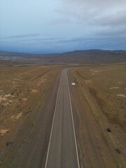 Aerial views of Patagonia, Argentina, featuring barren wastelands, rugged mountains, and dry plains. The photos capture the vast, remote wilderness, highlighting the dramatic Andean peaks.