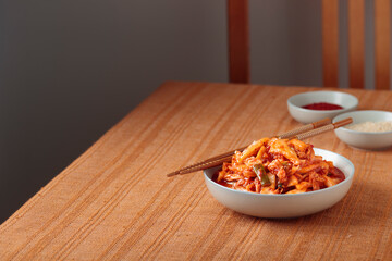 Kimchi, Kimchee in the Bowl, Red Spicy Kim Chi, Hot Fermented Napa Cabbage, Traditional Jimchi on a table