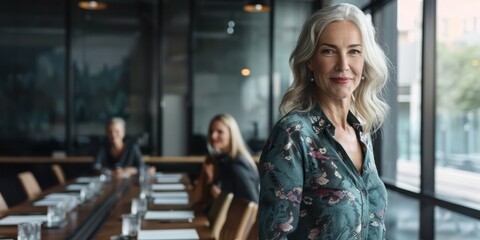 Fototapeta premium A confident woman standing at the head of a boardroom table, leading a meeting