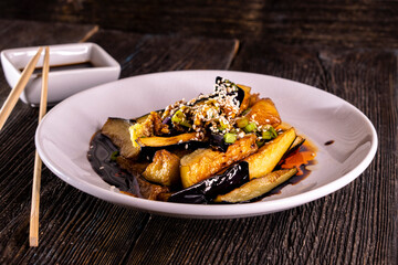 Di San Xian. Chinese Sautéed Potato Eggplants and Green Peppers  on wood table. Chinese food.