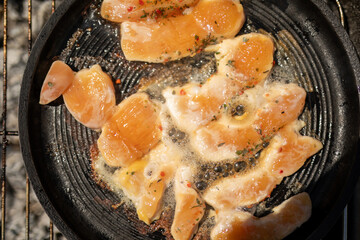 Chicken strips sizzling in a pan ready to be devoured