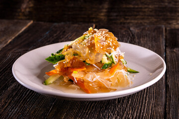 Chinese jellyfish salad on wood table. Chinese food. food concept. © Denis
