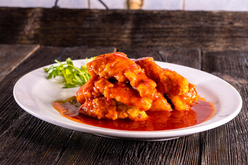 fried fish in sweet and sour sauce on wood table. Chinese food. food concept.