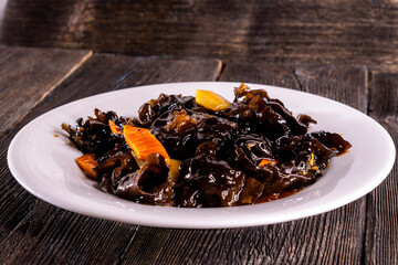 Wood Ear Mushroom Salad on wood table. Chinese food. wooden sticks, soy sauce. China Sichuan Food