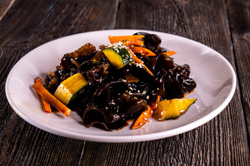 Wood Ear Mushroom Salad on wood table. Chinese food. wooden sticks, soy sauce. China Sichuan Food