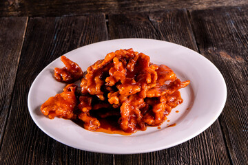 fried fish in sweet and sour sauce on wood table. Chinese food. food concept.