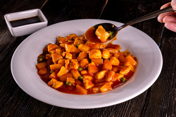 Chinese Pineapple Chicken on a wooden background. Food concept. Chinese food.