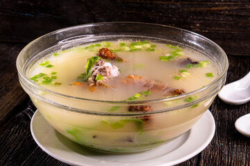Peking duck soup on wood table.Chinese food. food concept.