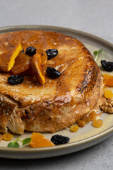 cake with dried apricots, raisins and walnuts on grey background