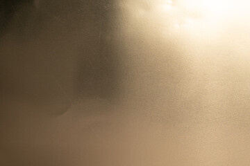 A textured golden background with a subtle light source