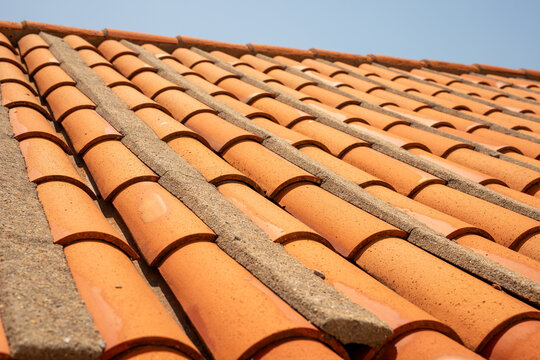 A close up of a terracotta roof showing the intricate details and the warm earthy tones of the tiles