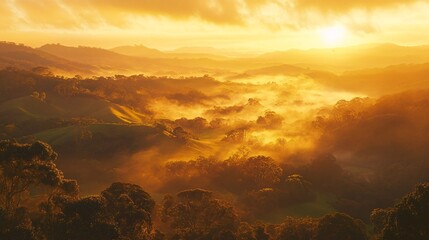 Golden sunrise over misty hills and valleys