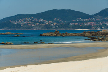 View of Playa de Samil, the main beach of Vigo in Galicia in northwest Spain. Sunny day, crystal clear blue sea