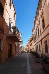 Charming Cobblestone Street in a Sardinian Town Under Blue Skies