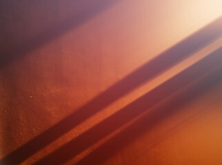 Diagonal bright sun beams falling on the room wall