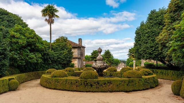 Beautiful fountain with lush vegetation in the gardens of the Pazo de Oca, Galicia.