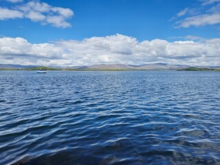 Tranquil Waterscape: A Peaceful River Reflecting Waves And Clouds In Nature