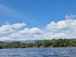 Serene Waterscape: Tranquil River With Cloud Reflections And Gentle Ripples