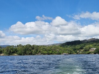 Serene Waterscape: Little Waves And Cloud Reflections On A Tranquil River