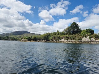 Serene Waterscape: Little Waves And Cloud Reflections On A Tranquil River