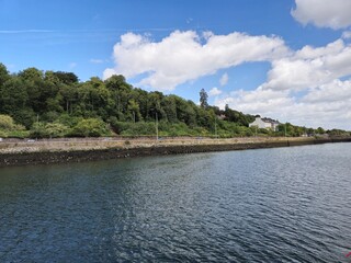 Serene River Waterscape With Cloud Reflections And Gentle Waves