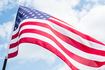 The vibrant American flag flutters against a clear blue sky, symbolizing freedom and patriotism.