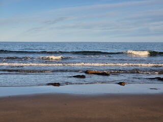 Summer Day At The Blue Ocean Shore: Waves And Golden Sand