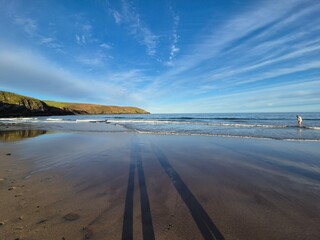 Sunny Summer Day At The Beach: Waves Lapping On The Golden Shoreline