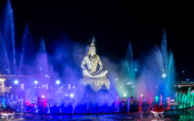 dramatic idol of hindu holy god lord shiva sitting in mediation at outdoor at night