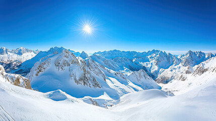 Fototapeta premium Majestic panoramic view of snow-covered mountains under a bright blue sky with the sun shining over the peaks