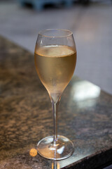Tasting of brut and reserve grand cru champagne sparkling wine produced by traditional method in underground caves in Champagne, France, close up