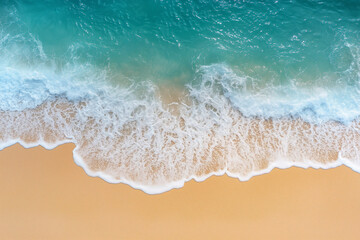 Beautiful beach with soft waves on a sandy background, top view.