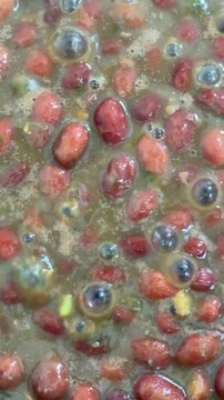 Close up of delicious beans boiling while being cooked.