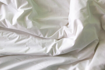 wrinkle messy blanket after waking up in the morning from sleeping in a long night, details of duvet and blanket.