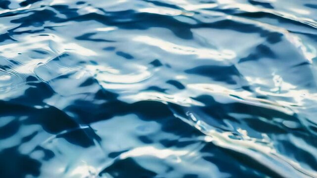 Rippling blue water surface in sunlight, abstract