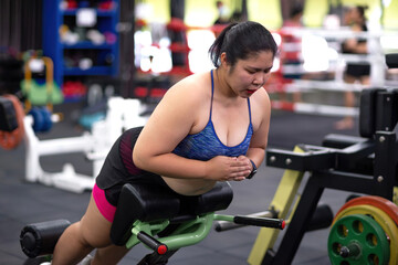 fat motivated woman exercise workout machine. fitness gym member trying to balance body exercise to reach healthy goal. determined person aim for changing life activity target for good strong body