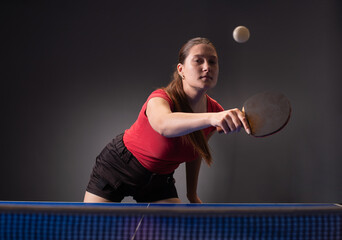 Young girl plays table tennis