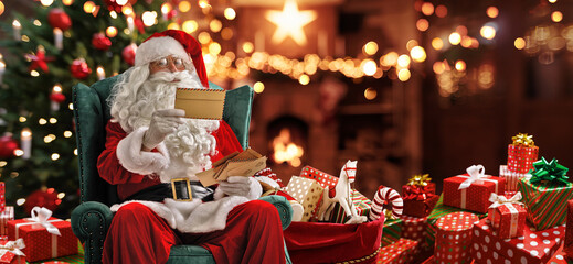 Santa Claus sits in his room and reads letters and a list of Christmas wishes