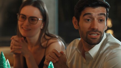 Portrait couple sitting with engaging lively conversation with group friend at luxurious counter bar while waiting cocktail alcohol drinks menu in special festive meeting at pub restaurant. Vinosity.