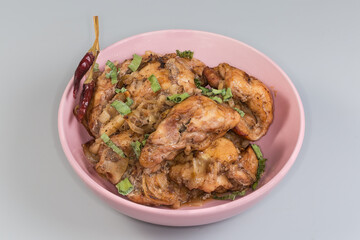 Baked chicken meat in pink bowl on a gray background