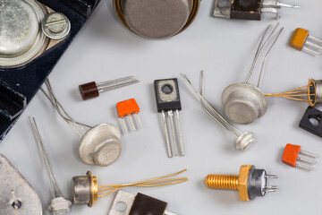 Old transistors various purpose in different packages on gray surface