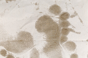 Surface of disposable paper towel with wet footprints, top view