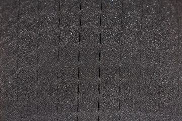 Texture of the black foam rubber surface in selective focus