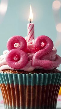 Birthday cupcake with burning lit candle with number 82. Number eighty-two for eighty-two years or eighty-second anniversary.