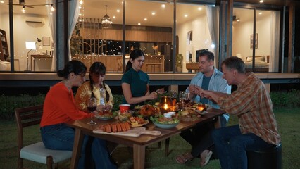 Family holding sparkler in holiday celebration dinner party. Family member enjoy play spark together. Outdoor activity spending time with toy cross generation gap strengthen family bond. Divergence.