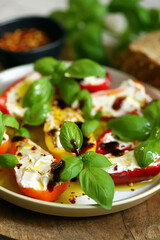 Mini peppers stuffed with cream cheese in olive oil with basil
