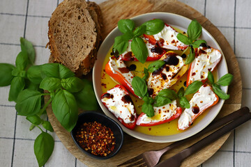 Mini peppers stuffed with cream cheese in olive oil with basil