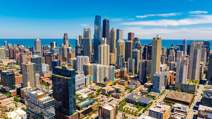 Fototapeta premium Splendid scenery of modern Chicago downtown on beautiful clear sunny day. Drone footage above the cityscape.